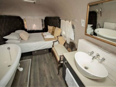 Life Before Colour: bed, clawfoot bath and vessel basin in the Airstream, Old Mac Daddy, Elgin Valley