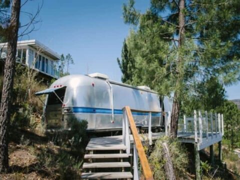 Life Before Colour: the silver Airstream on a pine slope, steps up to its deck, Old Mac Daddy, Elgin Valley