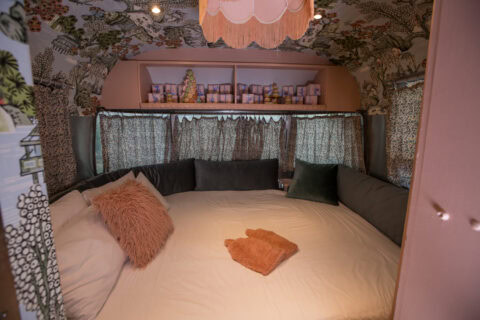 Love Cake: bed with pink cushions under a fringed lampshade, botanical wallpaper, Old Mac Daddy, Elgin Valley