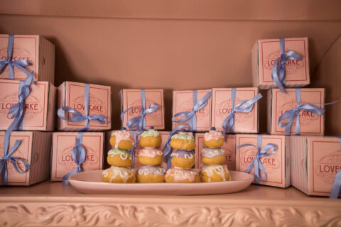 Love Cake: stacked pink Love Cake boxes tied with blue ribbon, iced buns on a plate, Old Mac Daddy, Elgin Valley
