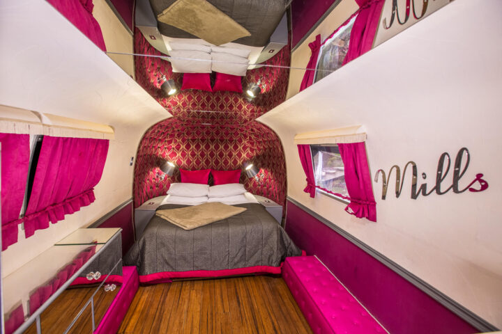 Mills & Boon: Airstream bed under a red quilted arch, hot-pink curtains and Mills lettering, Old Mac Daddy, Elgin Valley