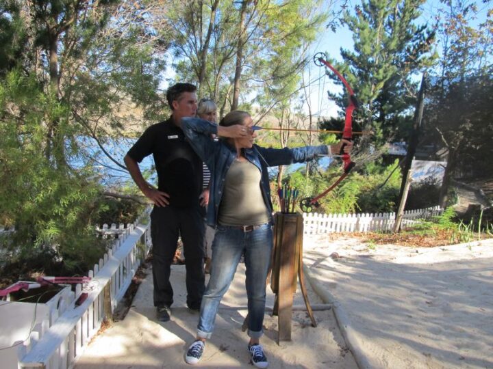 An instructor watching a woman draw a bow at the archery range, Old Mac Daddy, Elgin Valley