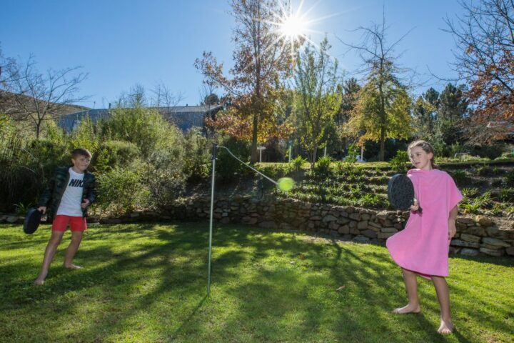 Two children playing a bat and ball game across a net on the lawn, Old Mac Daddy, Elgin Valley