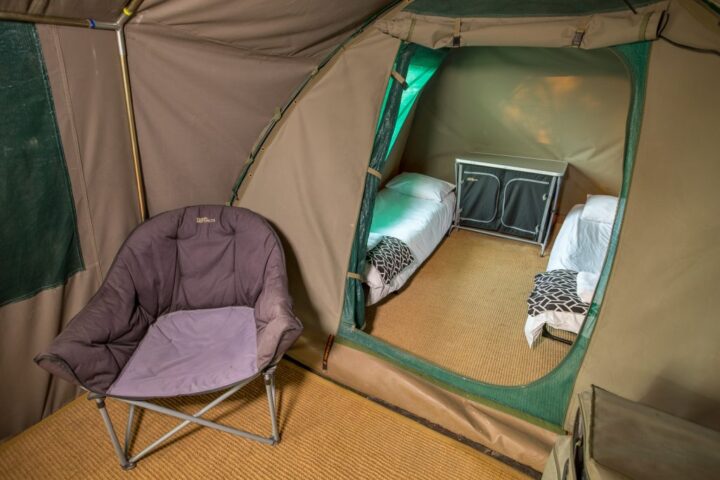 A canvas tent with two single beds and a padded camp chair, Old Mac Daddy, Elgin Valley