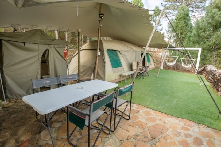 Camp table and chairs under a canvas awning beside the tents, Old Mac Daddy, Elgin Valley