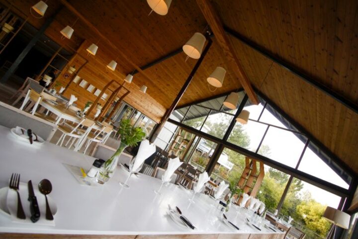 Wide view of the Barn restaurant with set tables under the timber roof, Old Mac Daddy, Elgin Valley