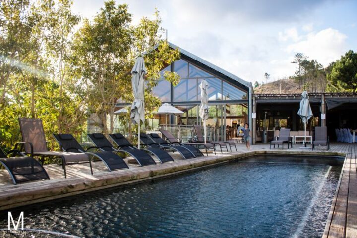 Pool with loungers and umbrellas in front of the glass-gabled Barn, Old Mac Daddy, Elgin Valley