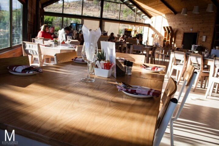 Set tables in the sunlit Barn restaurant, Old Mac Daddy, Elgin Valley