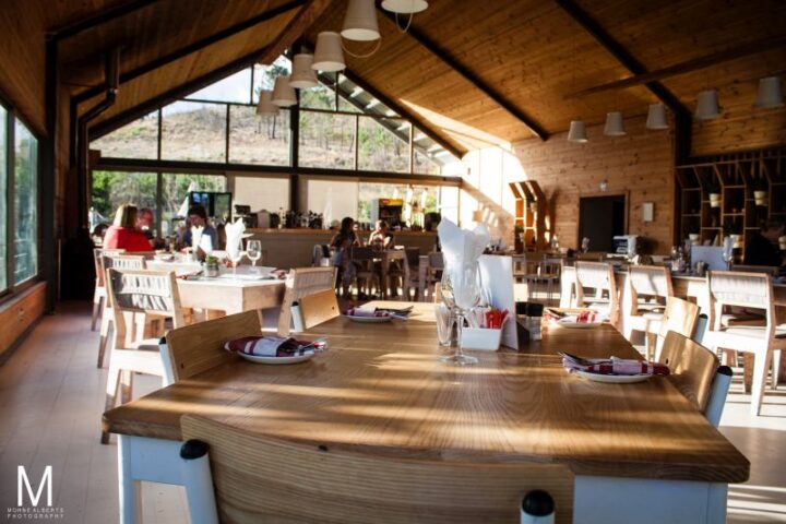 A long set table in the Barn restaurant with diners behind, Old Mac Daddy, Elgin Valley