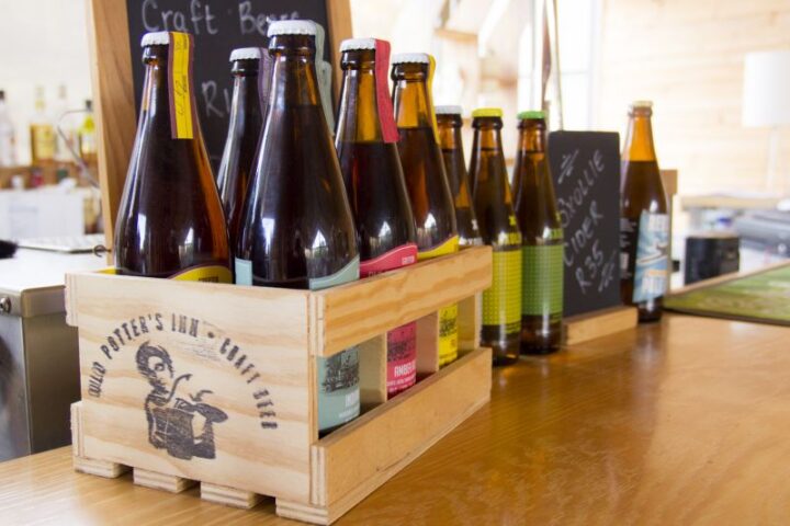 Craft beer bottles in a wooden crate on the bar, Old Mac Daddy, Elgin Valley