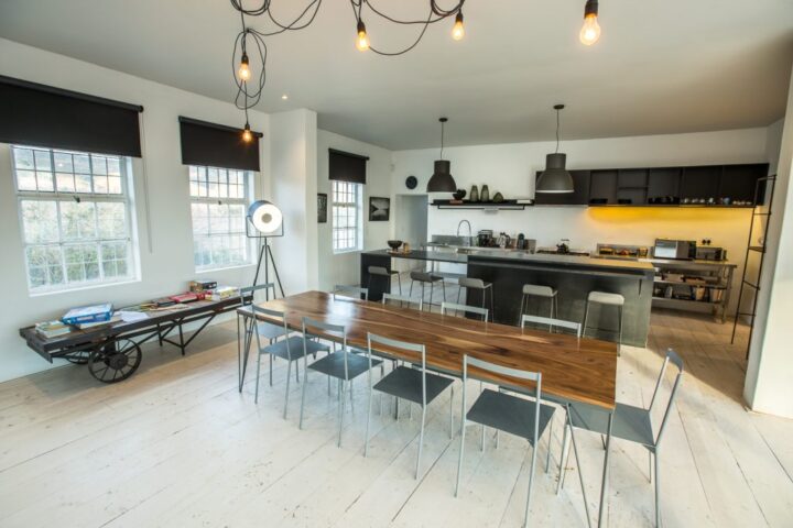 Villa kitchen and long dining table with pendant lights and sash windows, Old Mac Daddy, Elgin Valley