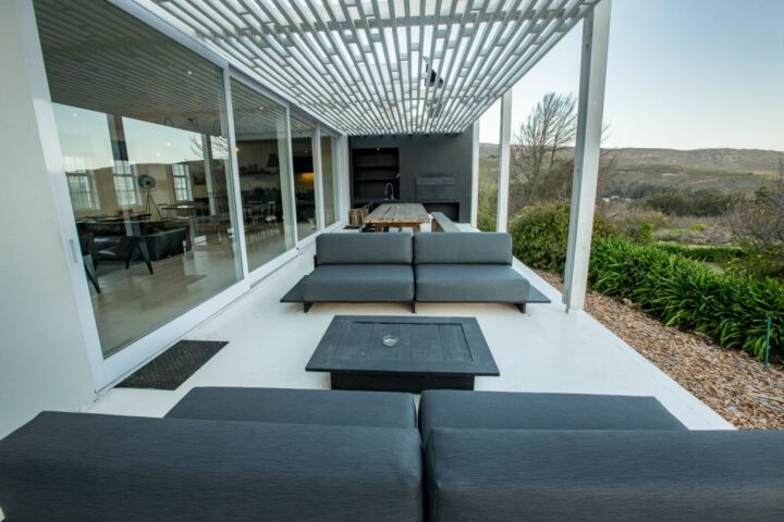 Villa patio with outdoor sofas under a white slatted pergola, Old Mac Daddy, Elgin Valley