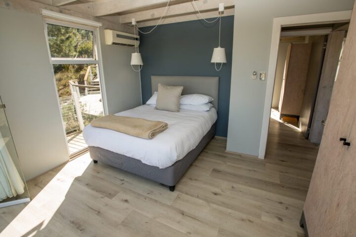 Villa bedroom with a single bed and a door onto the balcony, Old Mac Daddy, Elgin Valley