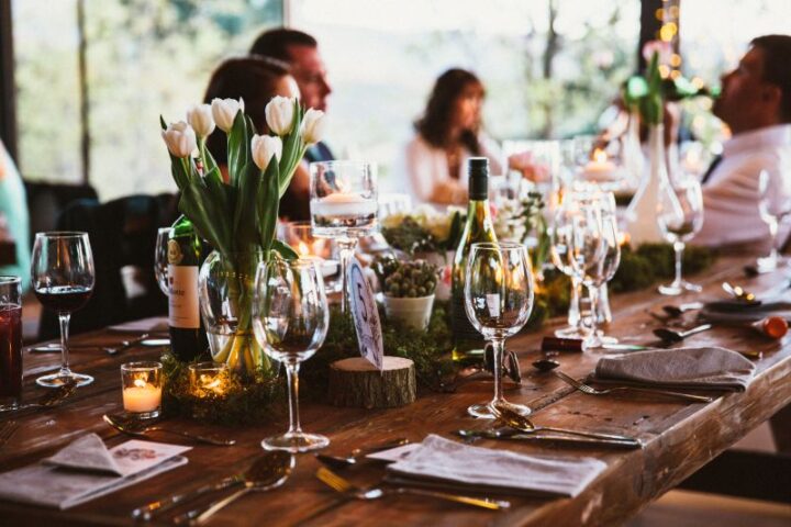 Guests at a reception table set with tulips, candles and wine glasses, Old Mac Daddy, Elgin Valley