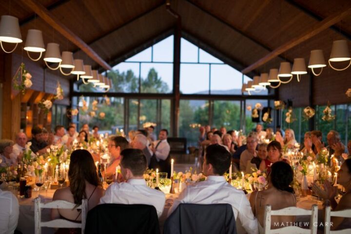 Guests at a candlelit wedding dinner in the Barn, Old Mac Daddy, Elgin Valley