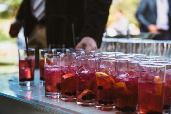 Rows of red drinks with orange slices on a table, Old Mac Daddy, Elgin Valley
